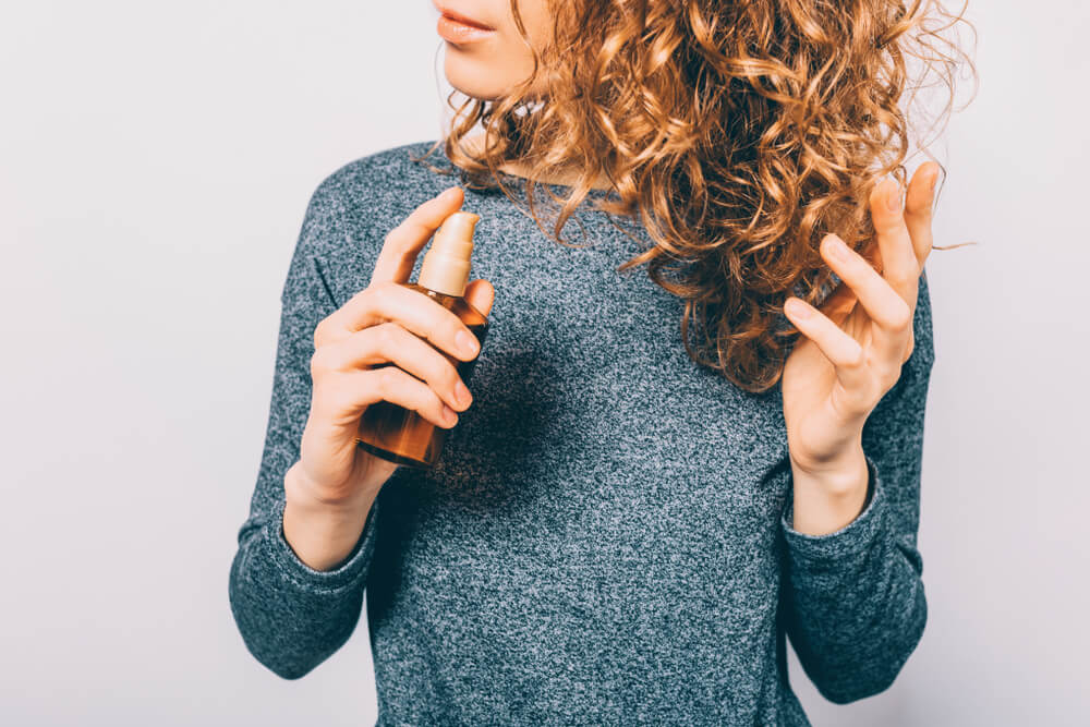 Woman using hair serum