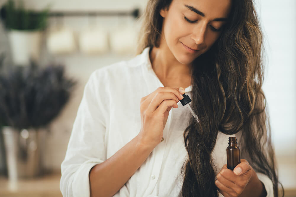 Woman using hair serum