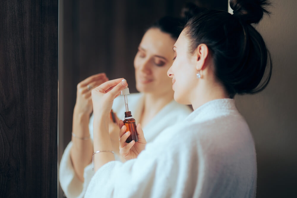 Woman applying skincare serum