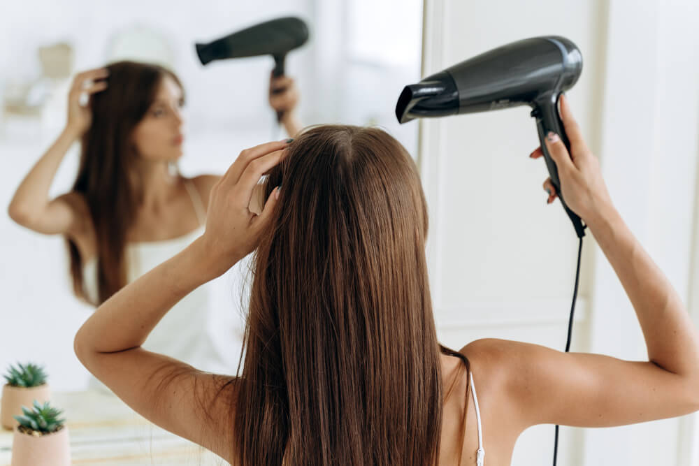 Woman creating hair dryer styles