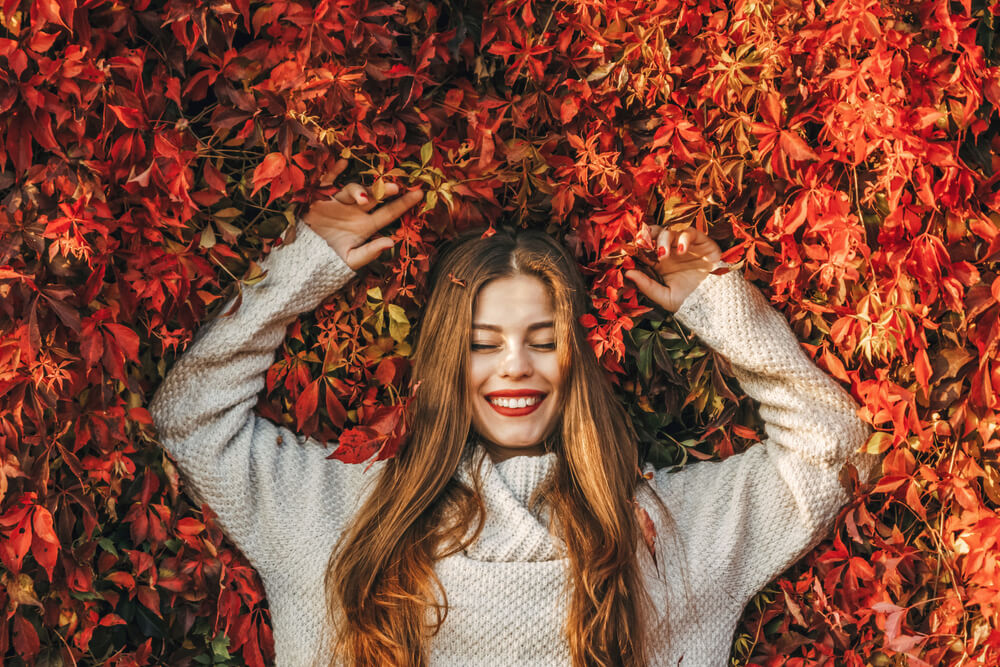 Woman lying in leaves