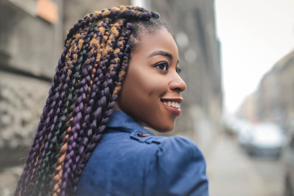 Woman with tight braids as one of the hair trends for holidays
