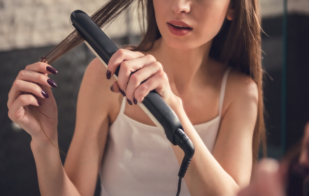 Woman showing uses of straightener