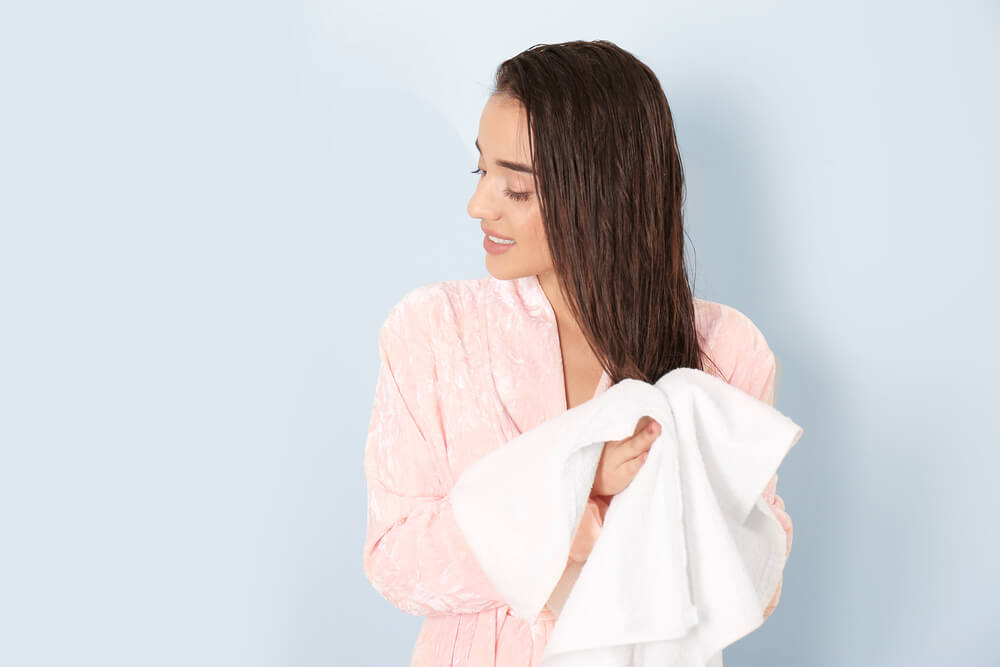 woman towel drying hair
