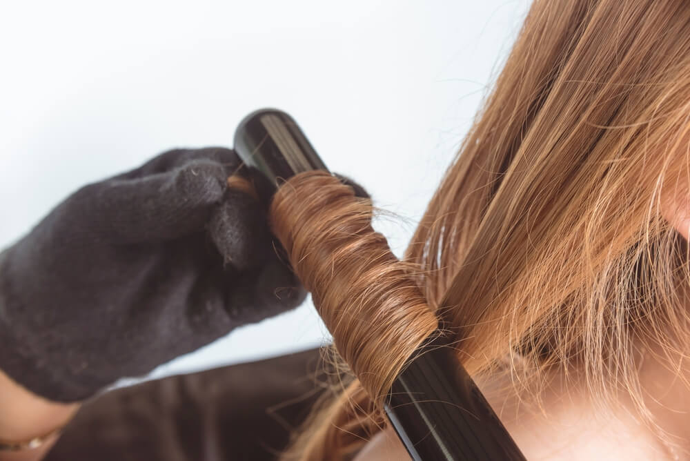 woman having hair curled