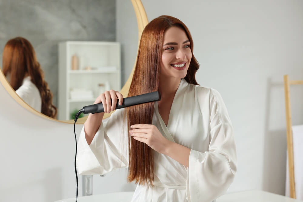 woman straightening hair