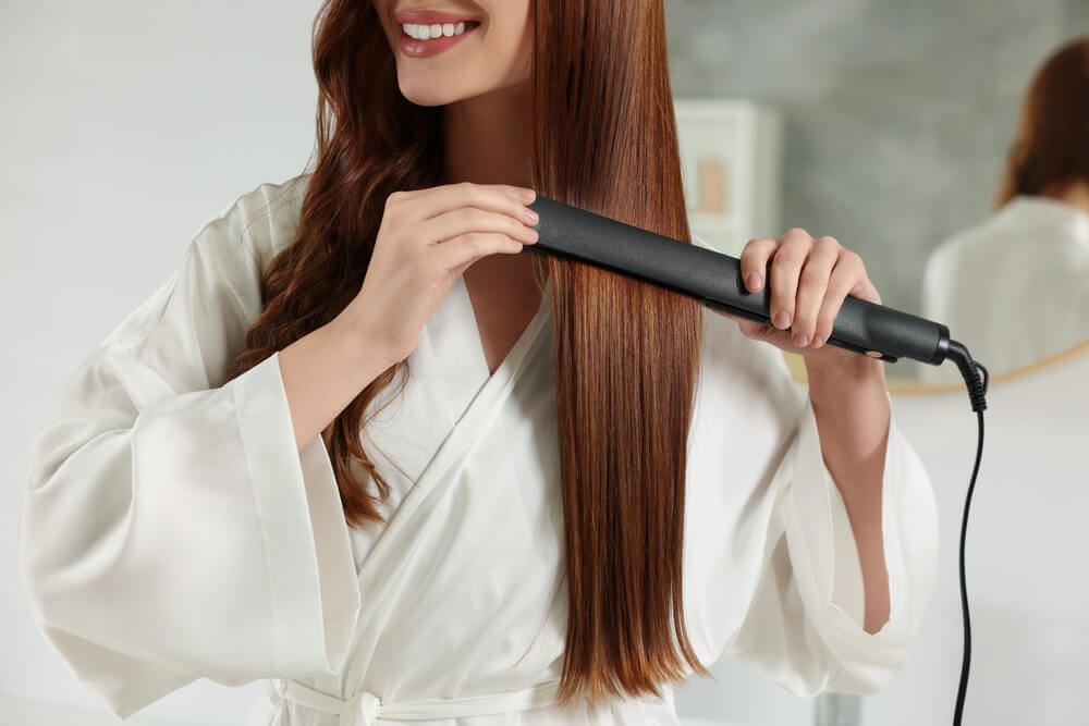 woman straightening hair