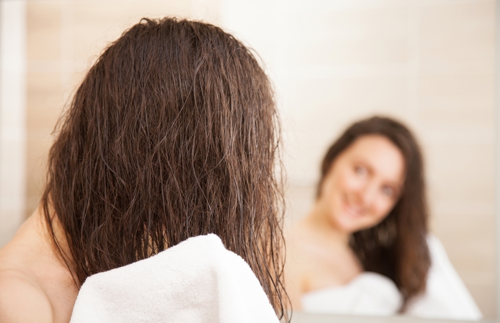 Woman drying hair with towel